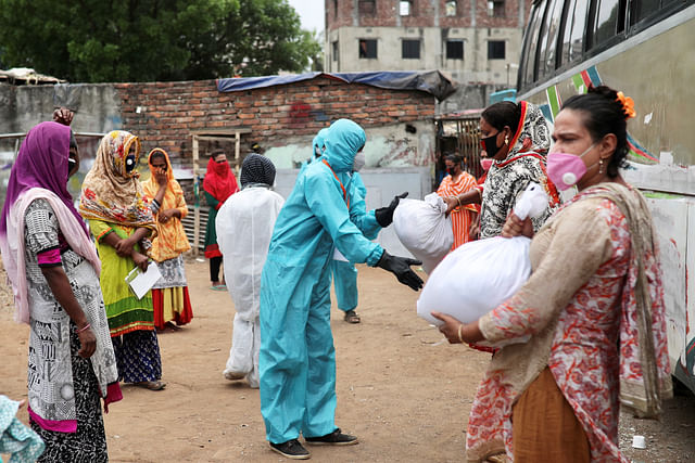 Volunteers from an organisation distribute relief supplies among transgenders, amid the coronavirus disease (Covid-19), in Dhaka, Bangladesh, 23 April 2020. 