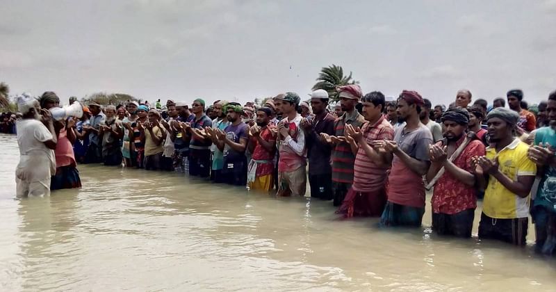 More than 2,500 people attended the Eid congregation standing in water. Photo: UNB