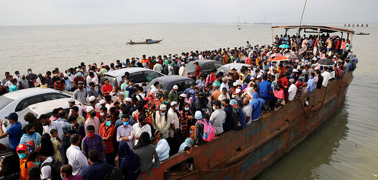 People seen on board of an overcrowded ferry, as they go home to celebrate Eid-ul-Fitr, amid concerns over the coronavirus disease (COVID-19) outbreak, in Munshiganj, Bangladesh, on 23 May 2020