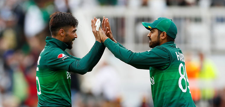 Pakistan's Mohammad Amir celebrates with Haris Sohail after taking the wicket of West Indies' Chris Gayle Trent Bridge, Nottingham, Britain on 31 May 2019.