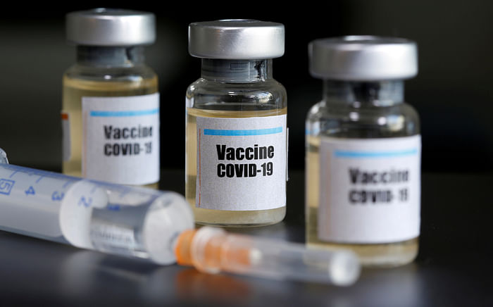 Small bottles labeled with a "Vaccine COVID-19" sticker and a medical syringe are seen in this illustration taken on 10 April 2020