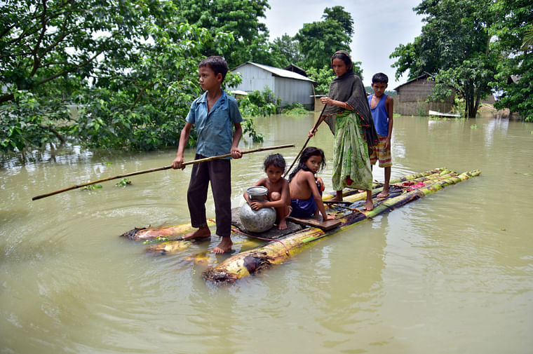 Villagers row a makeshift raft through a flooded field to reach a safer place at the flood-affected Mayong village in Morigaon district, in the northeastern state of Assam, India on 29 June.