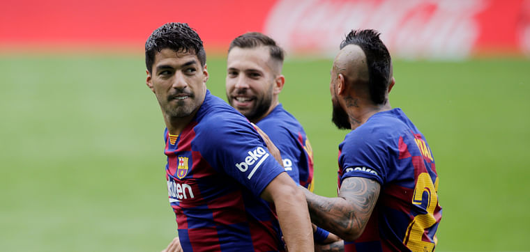 Barcelona's Luis Suarez celebrates scoring their first goal with teammates, as play resumes behind closed doors following the outbreak of the coronavirus disease (COVID-19).
