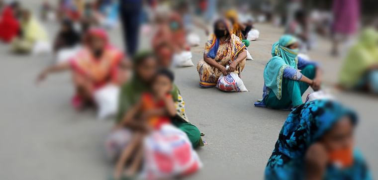 Women sit on the ground maintaining social distance waiting to receive relief supplies provided by local police authority amid the coronavirus disease (COVID-19) outbreak in Dhaka, Bangladesh, on 2 April 2020