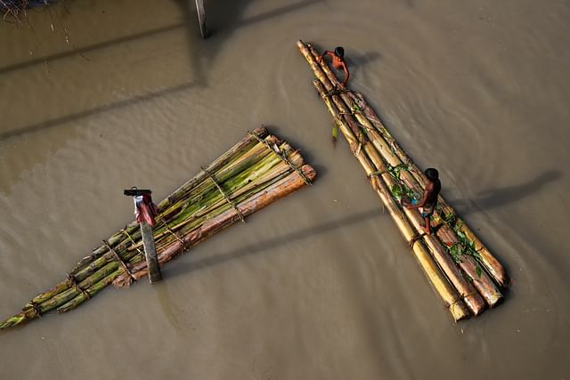 Children on makeshift rafts in flooded areas of Jamalpur, Bangladesh, 18 July 2020.