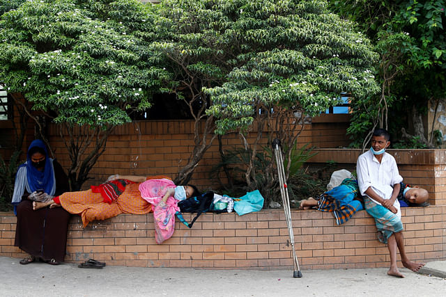 People wait in the queue outside of a coronavirus testing center as the coronavirus disease (COVID-19) outbreak continues in Dhaka, Bangladesh, on 2 July 2020