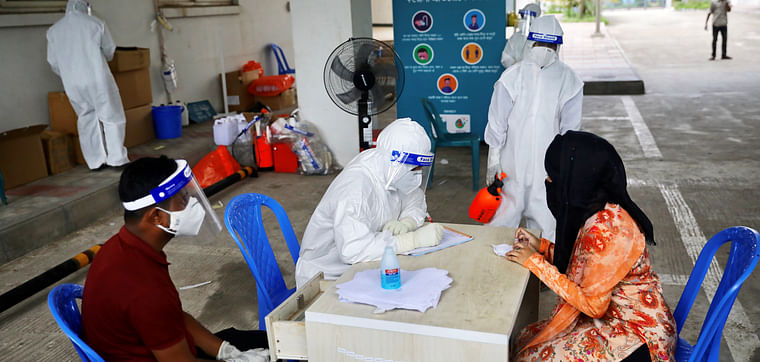 A woman consults a doctor before swab testing at Mugda Medical College and Hospital, as the coronavirus disease (COVID-19) outbreak continues, in Dhaka, Bangladesh, on 23 June 2020