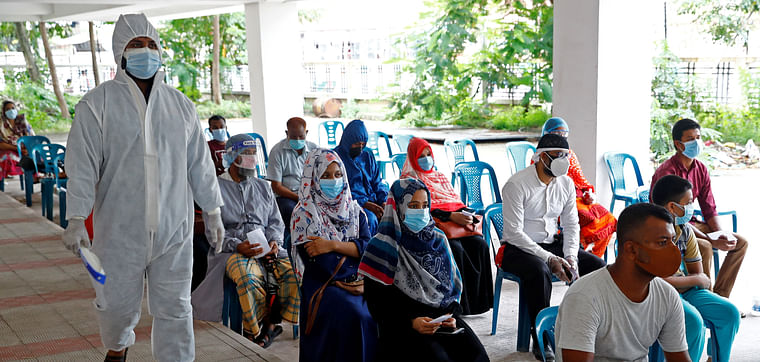 People sit as they come to a coronavirus testing center in the Mugda Medical College and Hospital as the coronavirus disease (COVID-19) outbreak continues in Dhaka, Bangladesh, 2 July 2020