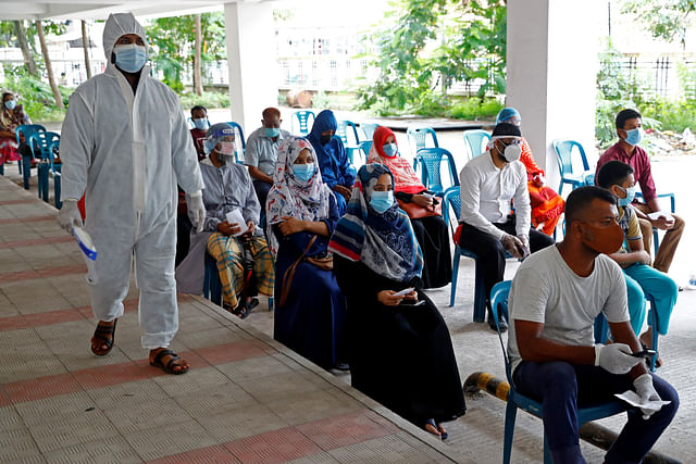 People sit as they come to a coronavirus testing centre in the Mugda Medical College and Hospital as the coronavirus disease (COVID-19) outbreak continues in Dhaka, Bangladesh, on 2 July 2020