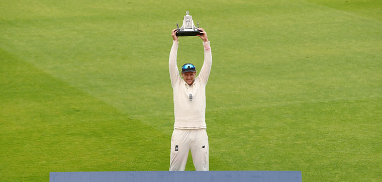 England's Joe Root celebrates winning the test series as he poses with the Wisden trophy by himself, after play resumed behind closed doors following the outbreak of the coronavirus disease (COVID-19)