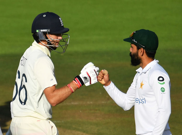 England's Joe Root and Pakistan's Fawad Alam fist pump after the Test match is drawn, as play resumes behind closed doors following the outbreak of the coronavirus disease (COVID-19) in Southampton, Britain on 17 August, 2020. 