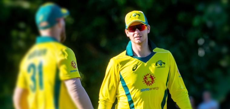 Australia`s Steve Smith (R) and David Warner speak during the second of three warm-up cricket matches between New Zealand and Australia in Brisbane on 8 May 2019