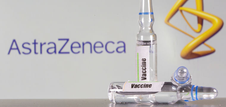  A test tube labeled with the vaccine is seen in front of AstraZeneca logo in this illustration taken, 9 September, 2020.