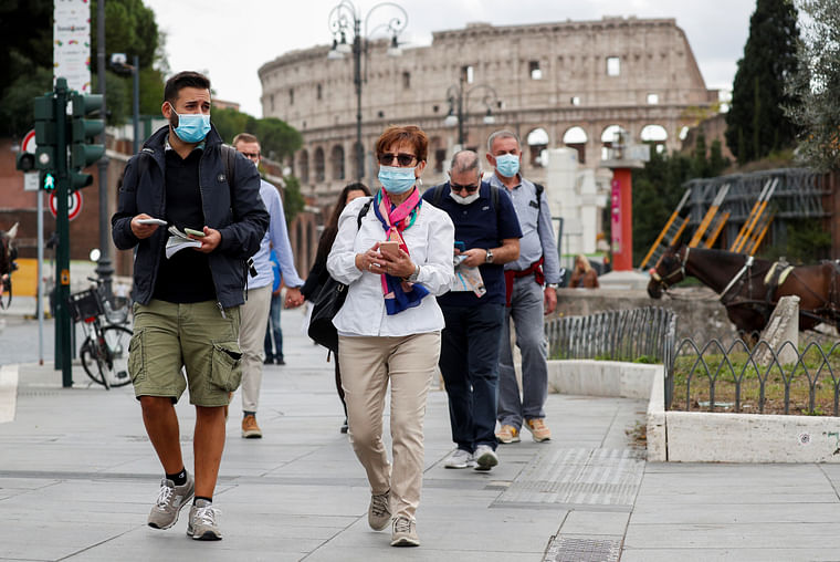 People wear face masks as local authorities in the Italian capital Rome order face coverings to be worn at all times out of doors in an effort to counter rising coronavirus disease (COVID-19) infections, in Rome, Italy, 2 October 2020.