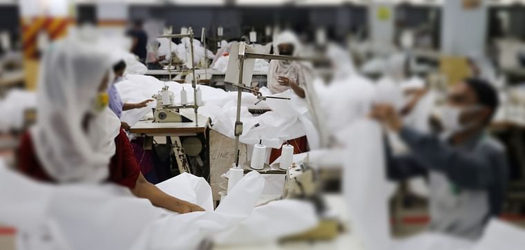 Bangladeshi garment workers make protective suit at a factory amid concerns over the spread of the coronavirus disease (COVID-19) in Dhaka, Bangladesh, on 31 March 2020