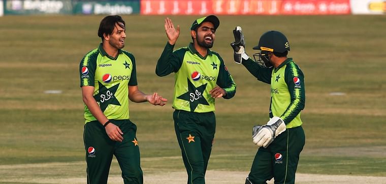 Pakistan's captain Babar Azam (C) celebrates with teammates after the dismissal of Zimbabwe's captain Chamu Chibhabha (not pictured) during the third Twenty20 cricket match between Pakistan and Zimbabwe at the Rawalpindi Cricket Stadium in Rawalpindi on 10 November 2020