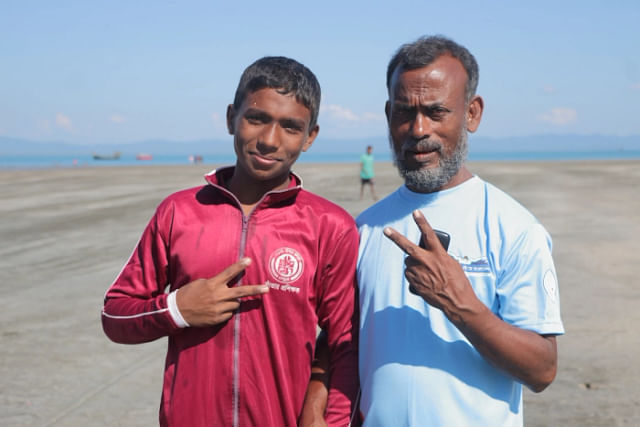 First place winner Rabbi Rahman is with his father Alalur Rahman after finishing the swimming competition on 30 November, St. Martin