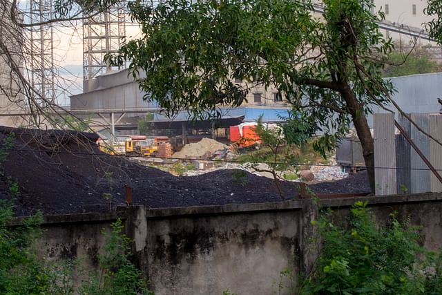 Boundary wall around the grabbed land. Big and small establishments are being constructed inside. 