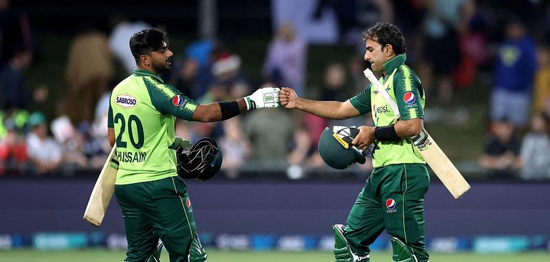 Pakistan's batsmen Hussain Talat (L) and Iftikhar Ahmed celebrate victory in the third T20 cricket match between New Zealand and Pakistan at McLean Park in Napier on 22 December 2020