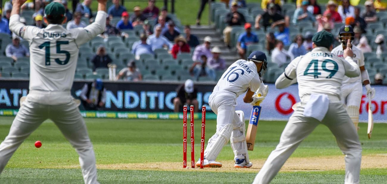 India's batsman Mayank Agarwal (C) is celan bowled by Australia's paceman Pat Cummins on day one of the First cricket Test match between Australia and India in Adelaide on 17 December 2020
