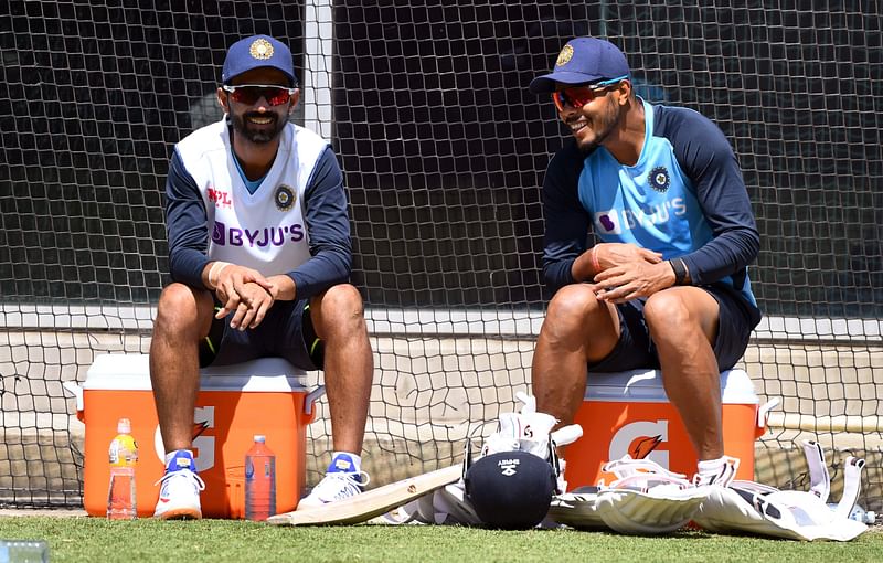 India's captain Ajinkya Rahane (L) chats with Umesh Yadav (R) during a training session ahead of the second cricket Test match against Australia, in Melbourne on 24 December, 2020
