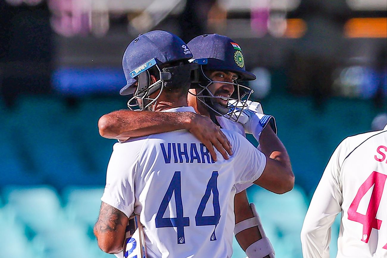 India's Ravichandran Ashwin embraces his teammate Hanuma Vihari (#44) at the end of the third cricket Test match between Australia and India at the Sydney Cricket Ground (SCG) in Sydney on 11 January , 2021
