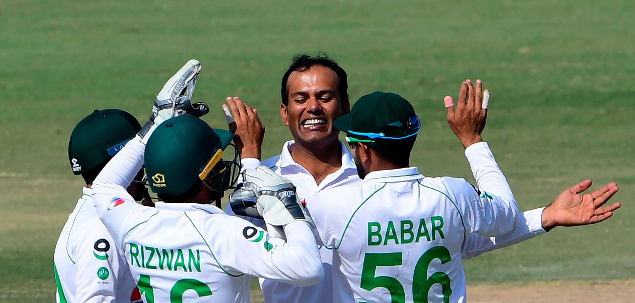 akistan's Nauman Ali (2R) celebrates with teammates after taking the wicket of South Africa's Anrich Nortje (not pictured) during the fourth day of the first cricket Test match between Pakistan and South Africa at the National Stadium in Karachi on 29 January , 2021.
