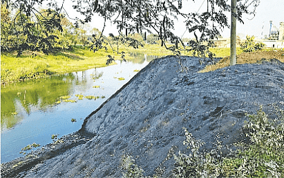 Local rice mills dump tons of ash into River Bangshi in Dhamrai every day