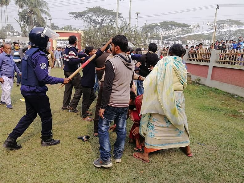 Police man in action as supporters of two candidates clash at Kishoreganj's Katiadi