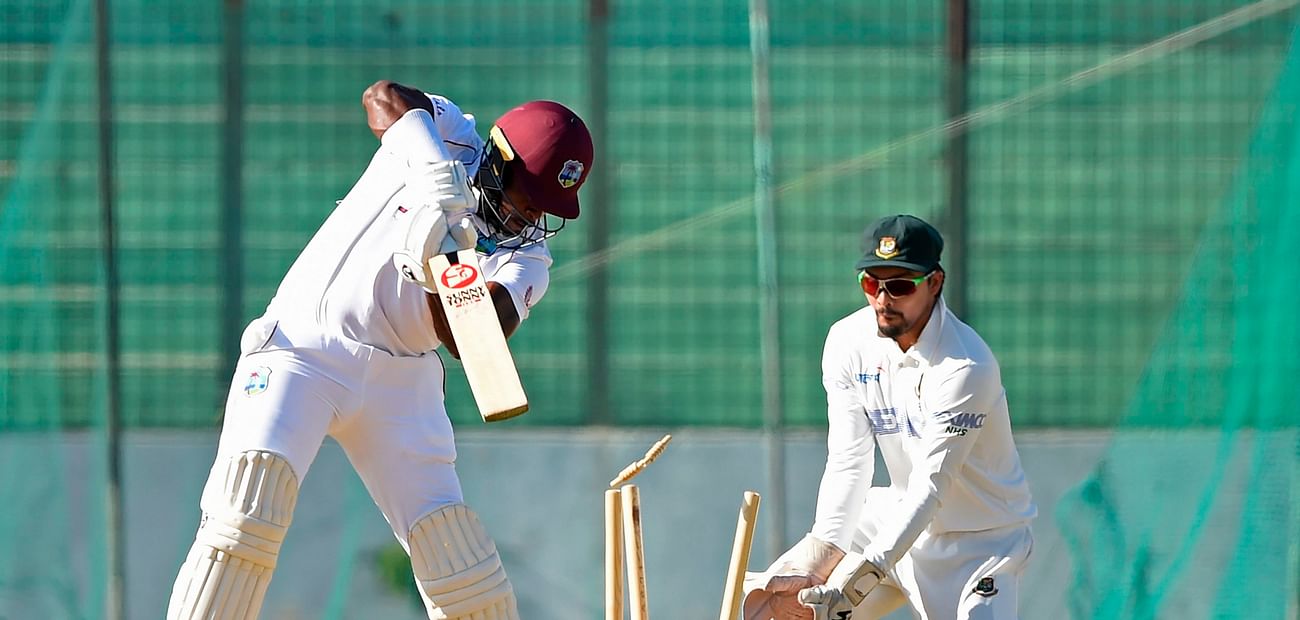 West Indies' Kyle Mayers (L) is bowled out during a tour match between West Indies’ and Bangladesh Cricket Board XI at the MA Aziz Stadium in Chittagong on 29 January, 2021