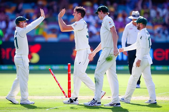 Australia's Pat Cummins (2nd-L) celebrates the wicket of India's Shardul Thakur, bowled for 67 during day three of the fourth cricket Test match between Australia and India at the Gabba in Brisbane on 17 January 2021