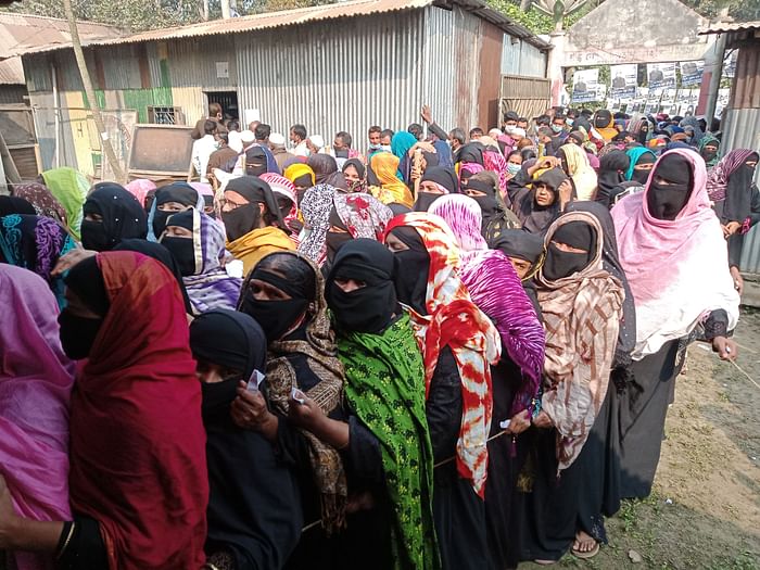Women stand in queue to cast ballots at Al-Helal Kindergarten in Sonaimuri municipality of Noakhali on Sunday. 