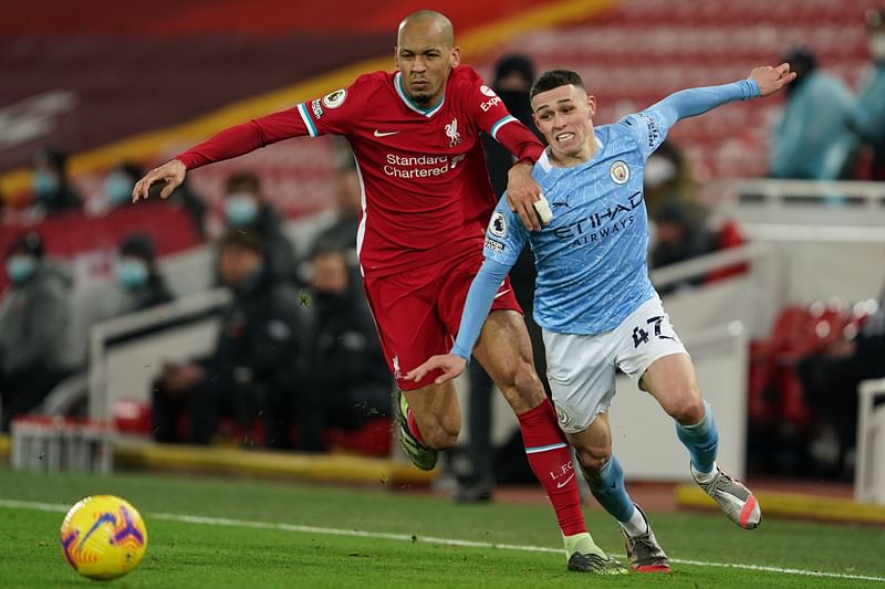 Liverpool's Brazilian midfielder Fabinho (L) vies with Manchester City's English midfielder Phil Foden (R) during the English Premier League football match between Liverpool and Manchester City at Anfield in Liverpool, north west England on 7 February, 2021