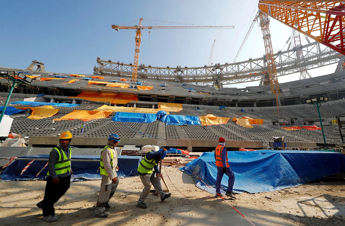Migrant workers constructing a football stadium in Qatar