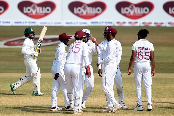 West Indies' players celebrate after the dismissal of Bangladesh's captain Mominul Haque (L) during the first day of the first cricket Test match between Bangladesh and West Indies at the Zohur Ahmed Chowdhury Stadium in Chattogram on 3 February 2021.