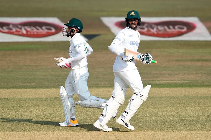 Bangladesh's Shakib Al Hasan (R) with teammate Mushfiqur Rahim run between the wickets during the first day of the first cricket Test match between Bangladesh and West Indies at the Zohur Ahmed Chowdhury Stadium in Chattogram on 3 February 2021.