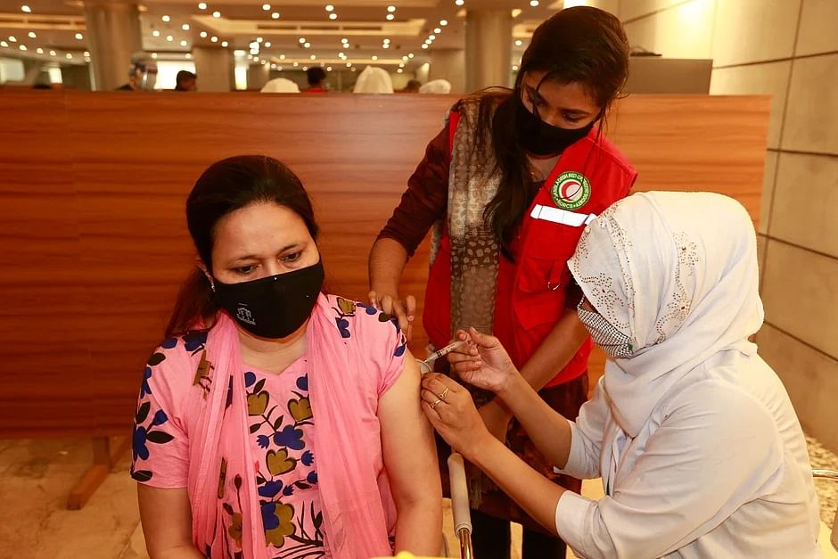 Health workers inoculate a woman with Covid-19 vaccine at Bangabandhu Sheikh Mujib Medical University Hospital in Dhaka.