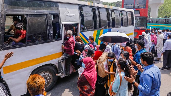 People in  to get into the bus amid the massive spike of Covid-19 situation in Bangladesh. The photo is taken recently from Shabagh intersection area, Dhaka. 