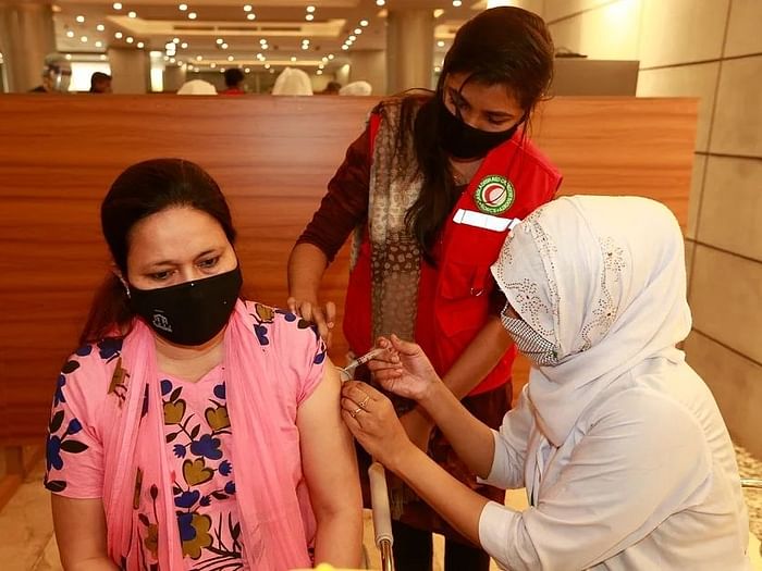 A woman takes COvid-19 vaccine at BSMMU, Dhaka
