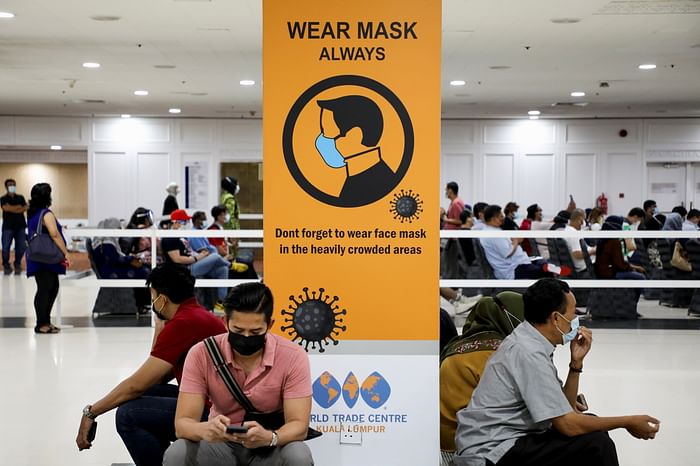 People wait to receive AstraZeneca's Covid-19 vaccine at a vaccination centre in Kuala Lumpur on 5 May 2021. 