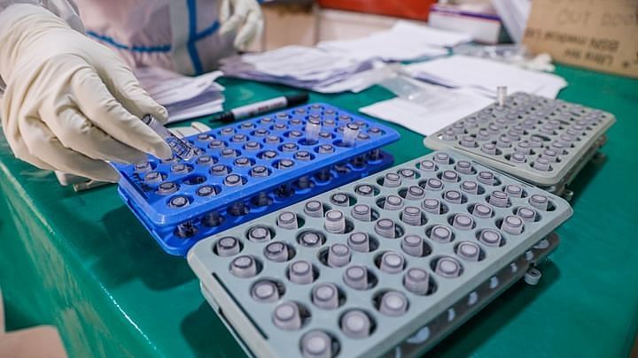 A health worker sorts test tubes with samples for testing coronavirus infection at a hospital