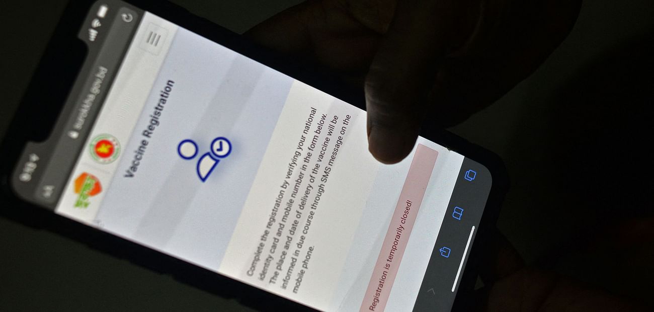 In this photo illustration taken on 21 May 2021, a user checks a government website on a mobile phone that is temporarily been closed for the Covid-19 coronavirus vaccine registration, in Dhaka.