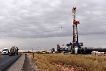 A drilling rig operates in the Permian Basin oil and natural gas production area in Lea County, New Mexico, US