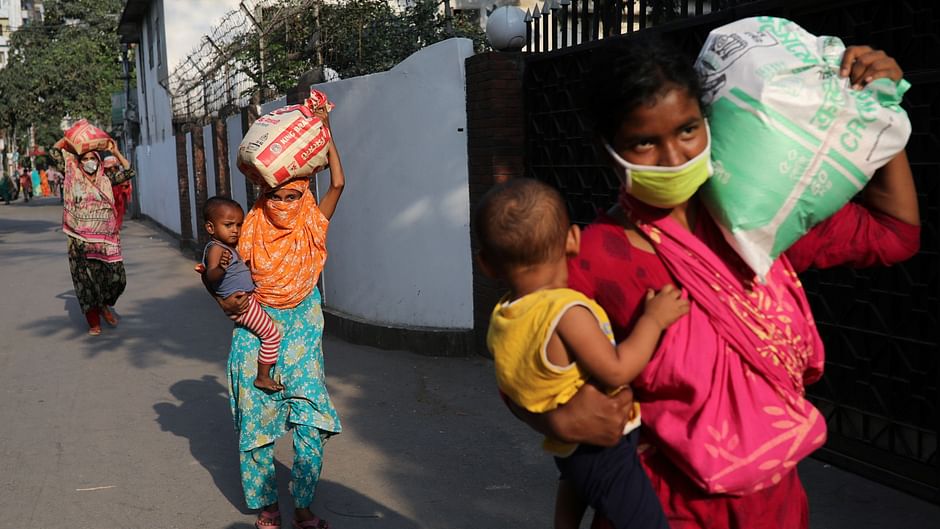 Women carry relief supplies amid the coronavirus disease (Covid-19) outbreak in Dhaka, Bangladesh