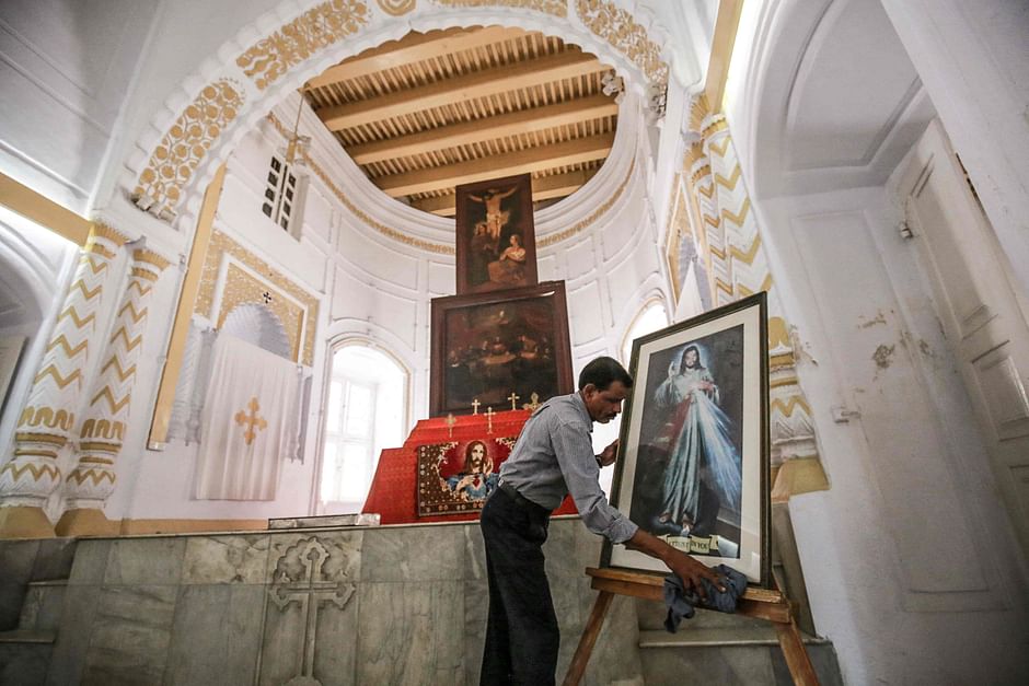 In this picture taken on 11 February 2021, devout Hindu Shankar Ghosh works inside of an Armenian Church in Dhaka