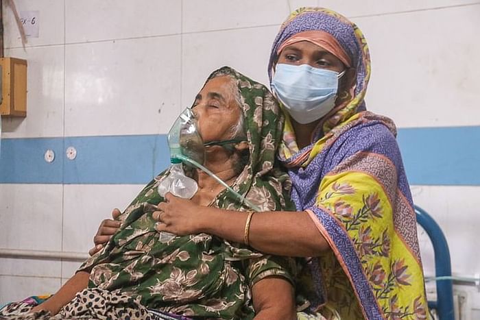 A 62-year-old woman who was infected with Covid-19 days back--grasping for air at a corona dedicated hospital in Khulna