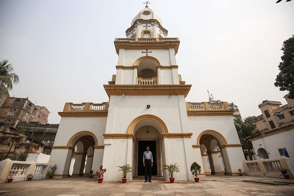 In this picture taken on 11 February 2021, devout Hindu Shankar Ghosh poses for a photo in front of an Armenian Church in Dhaka