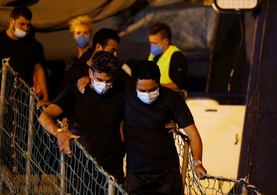 Migrants disembark from the German NGO migrant rescue ship Sea-Watch 3 after it arrived with 257 rescued migrants on board in Trapani on the island of Sicily, Italy 7 August 2021. 
