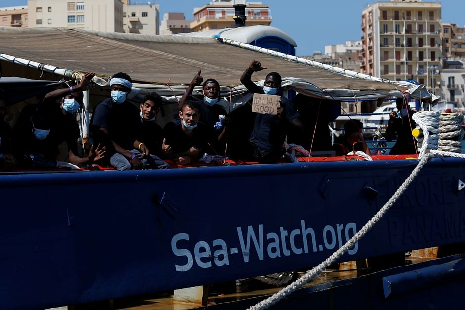 Migrants wait to disembark from the German NGO migrant rescue ship Sea-Watch 3 after it arrived with 257 rescued migrants on board in Trapani on the island of Sicily, Italy, 7 August 2021. 