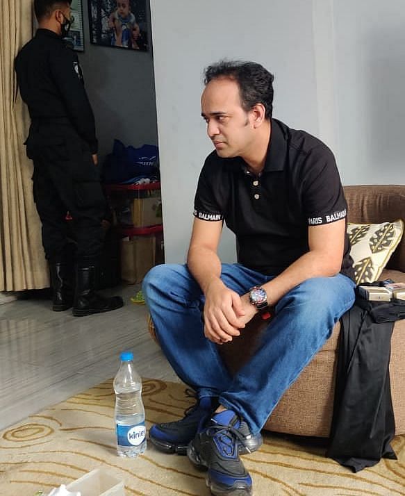 Evaly CEO Mohammad Rassel sits on a couch at his residence in Dhaka’s Mohammadpur during a raid by Rapid Action Battalion on Thursday, 16 September 2021. 